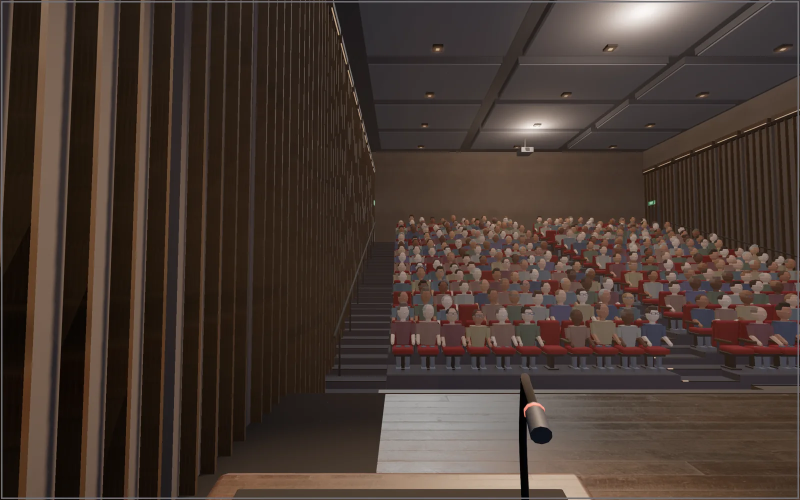 View from the podium: a microphone in front, three hundred seats rising away